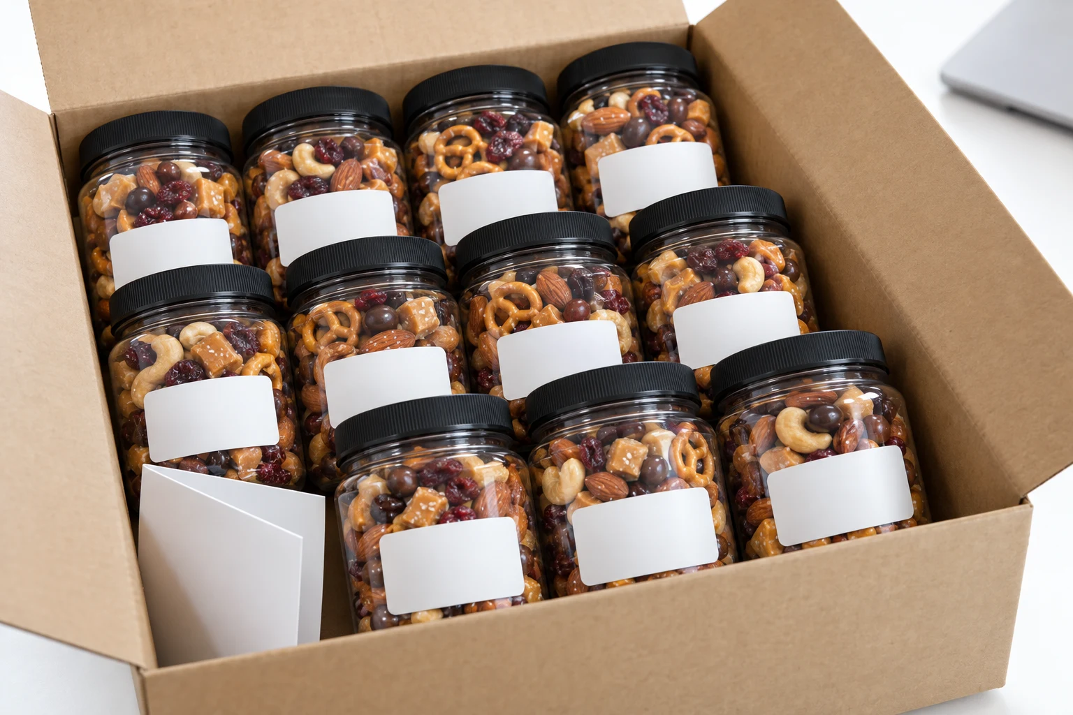 A dozen identical snack jars with a business name on the stickers in an open kraft case on a desk